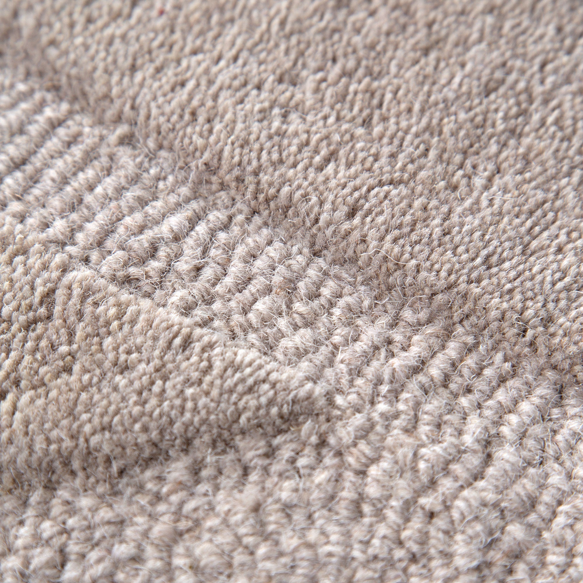 Get This Luxurious Les Nomades Beige Ellipse Hand - Tufted Wool Rug for Your Modern Space