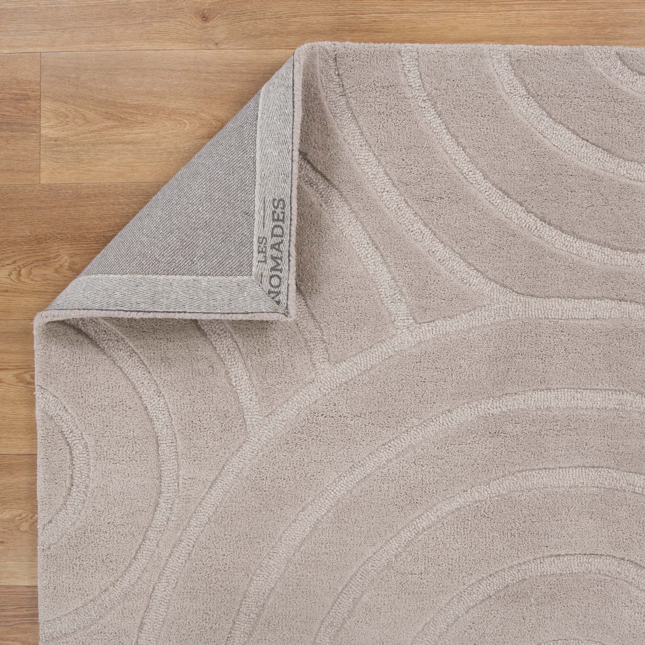 Get This Luxurious Les Nomades Beige Ellipse Hand - Tufted Wool Rug for Your Modern Space